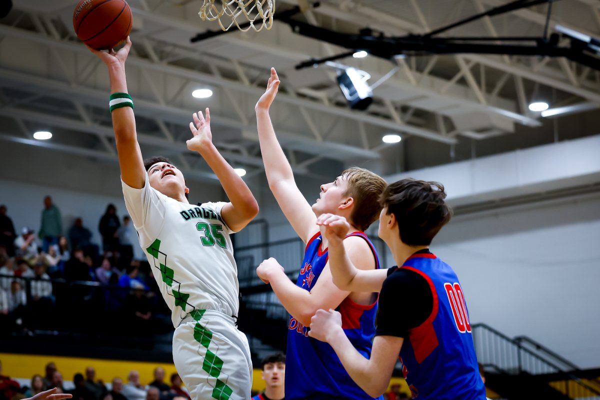 Harlan center Kobe Noe worked inside against Jackson County's Keagan Ward in Saturday's game at Clay County. Noe scored 19 points for the Dragons. Ward led Jackson County with 22 points and 12 rebounds.