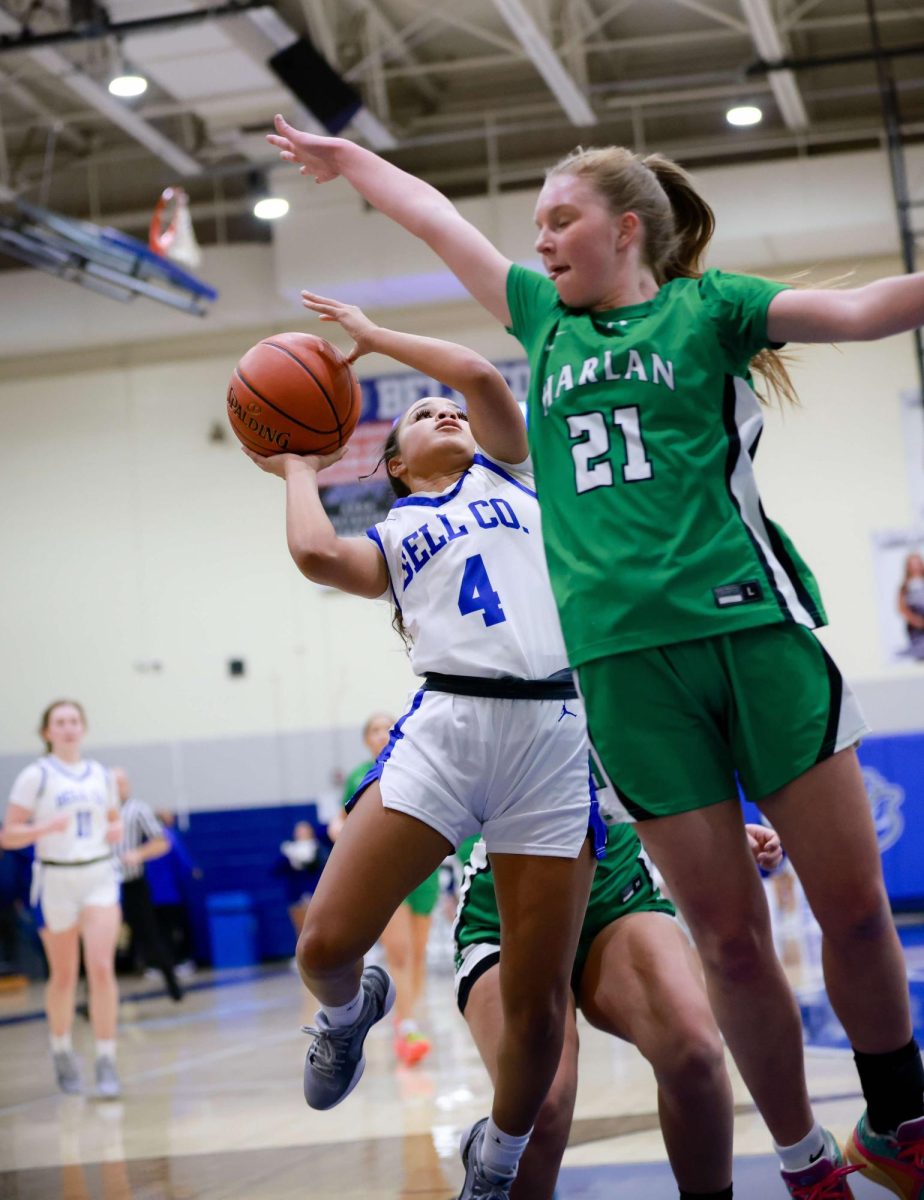 Bell County guard Lyla Scearse worked around Harlan's Cheyenne Rhymer for a shot in Tuesday's game at Log Mountain. Bell County edged the Lady Dragons 68-63.