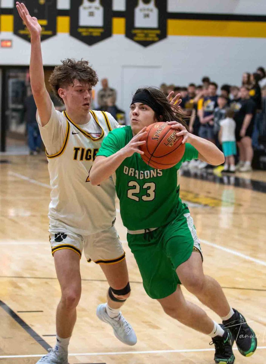 Harlan freshman forward Eli Noe went to the basket in Thursday’s game at Clay County. The Green Dragons fell 69-32.
