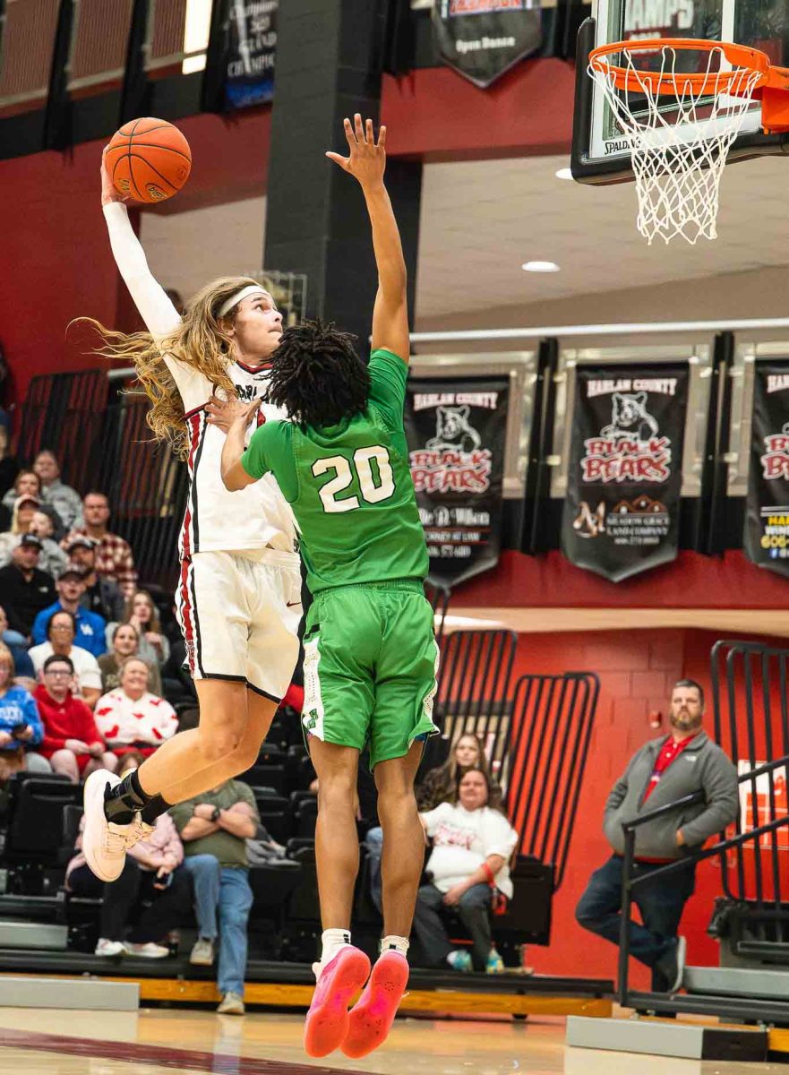 Harlan County guard Reggie Cottrell went up for a shot against Harlan's Nate Montanaro in Friday's district clash. The Black Bears rolled to a 73-21 win.