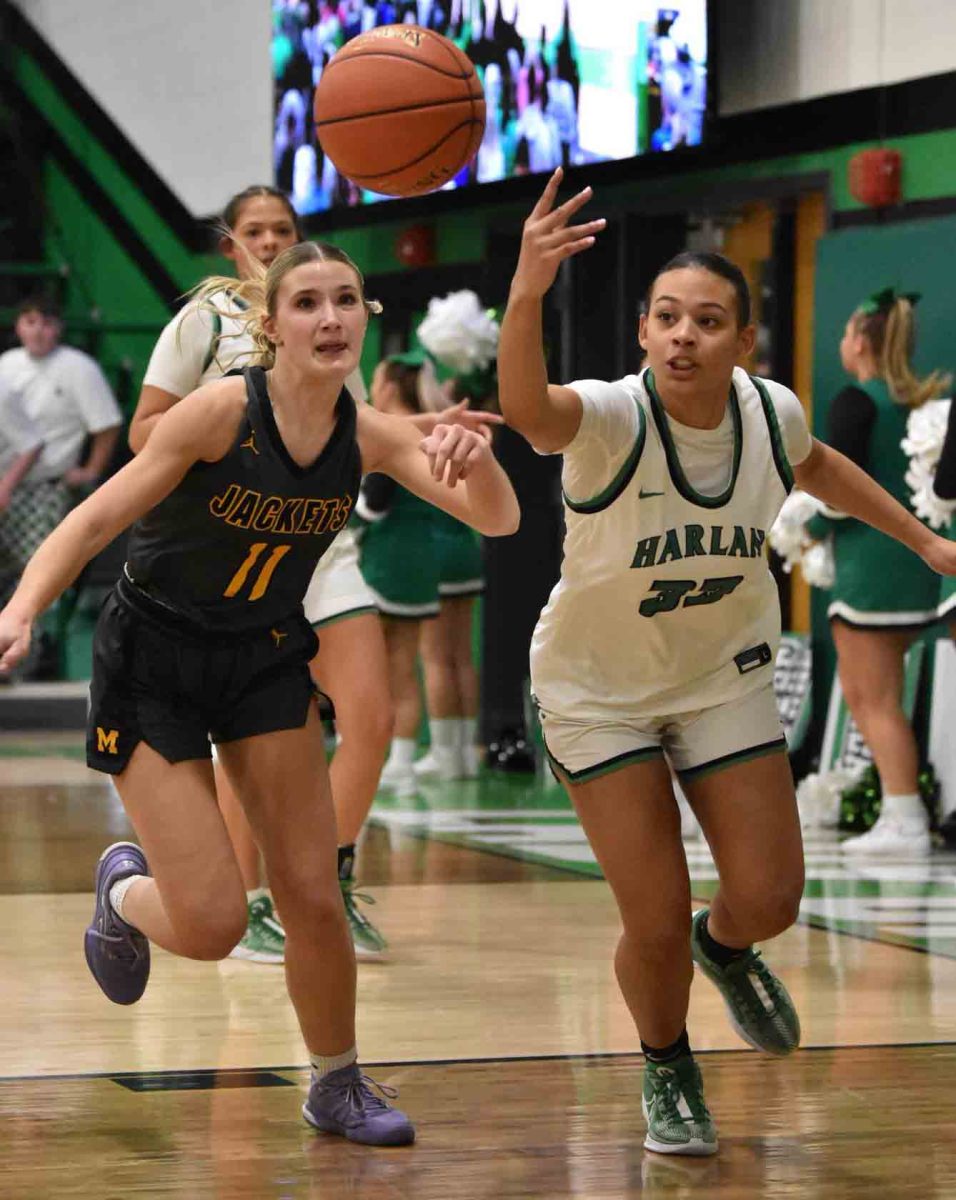 Middlesboro's Addyson Larew and Harlan's Raegan Goodman chased down a loose ball in action from the 52nd District Tournament on Monday. Harlan advanced with a 66-61 win.