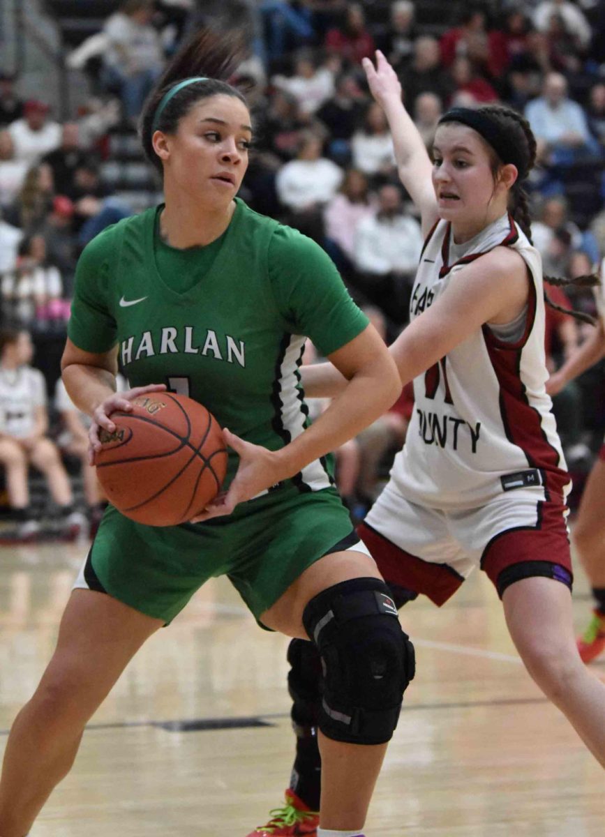 Harlan forward Kylie Noe worked against Harlan County's Reagan Clem in Friday's game. Noe scored 29 points in a 71-42 victory.