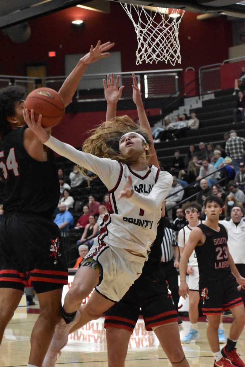 Harlan County guard Reggie Cottrell twisted his way around the South Laurel defense for a shot in Monday's 13th Region showdown. Cottrell finished with nine points, 12 rebounds and several big plays on defense in the Bears' 67-63 win.