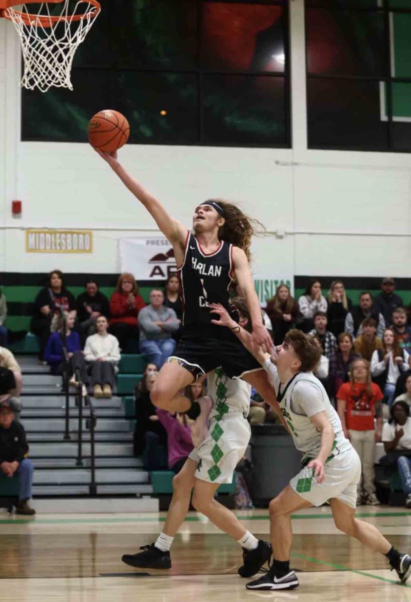 Harlan County guard Reggie Cottrell drew a foul as he went up for a shot in 52nd District Tournament action Tuesday. Cottrell scored 12 points in the Bears' 68-49 victory.