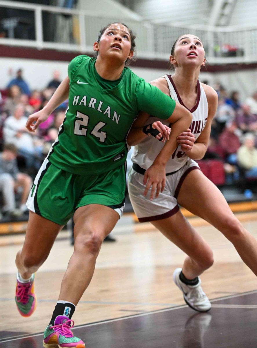 Harlan's Aymanni Wynn and Pineville's Ava Arnett battled for position in Thursday's game at the Lions Den. Wynn scored 33 points to lead the Lady Dragons to a 57-49 victory.