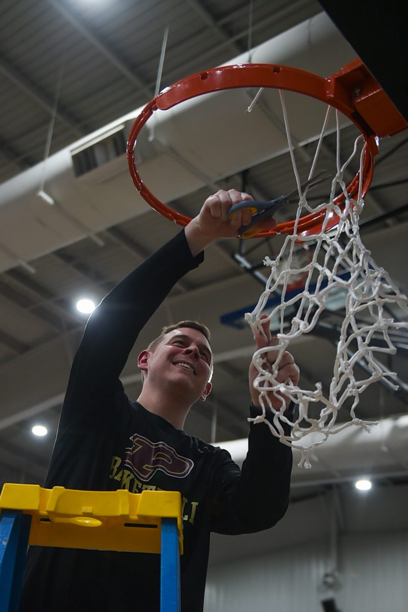 Pineville coach Brad Levy cut down a net after his Mountain Lions defeated Knox Central 76-71 in the 51st District Tournament finals Friday.
