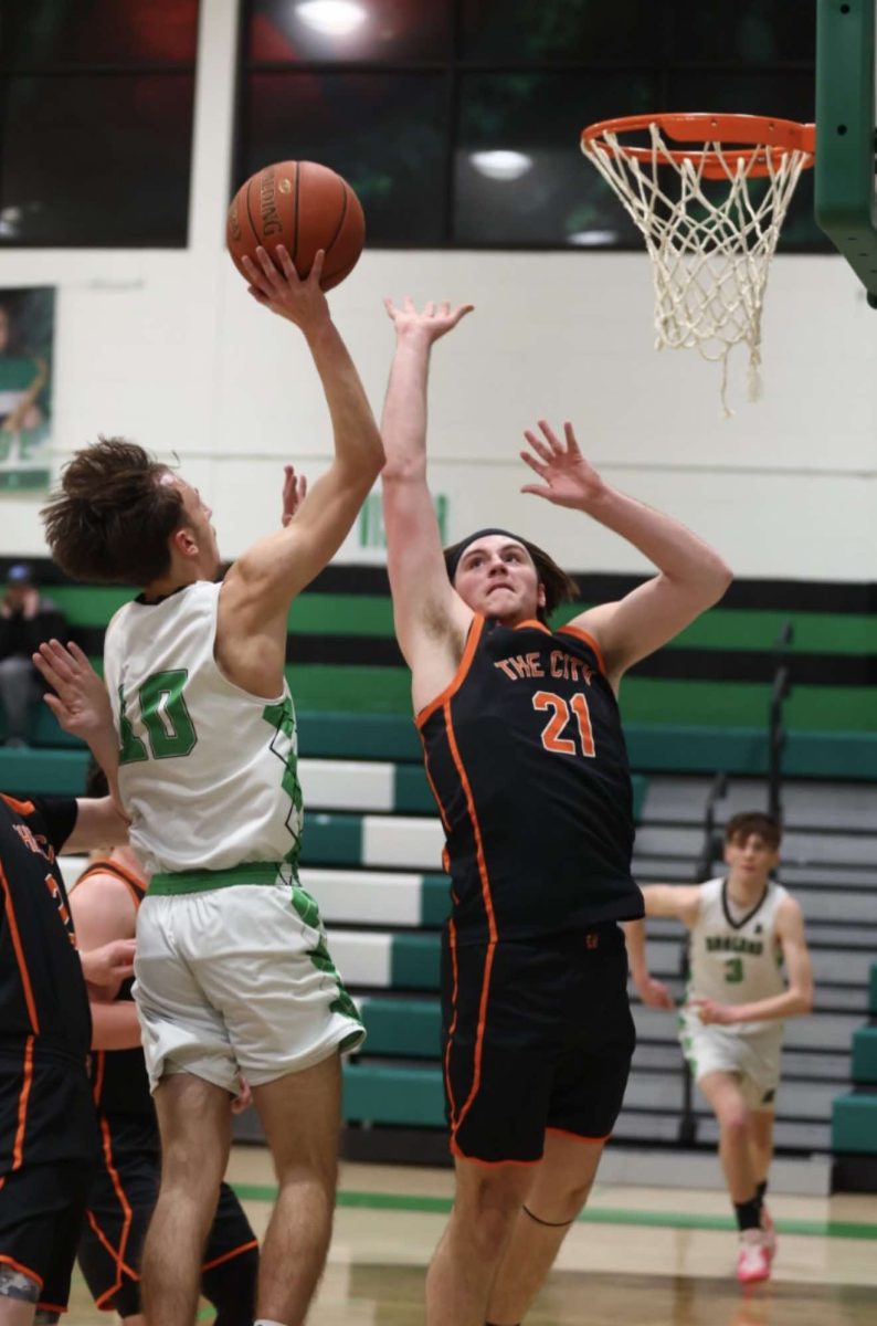 Harlan guard Dylan Cox put up a shot against Williamsburg's Andrew Smith in Thursday's game. Smith led the Jackets with 23 points in a 72-58 victory.