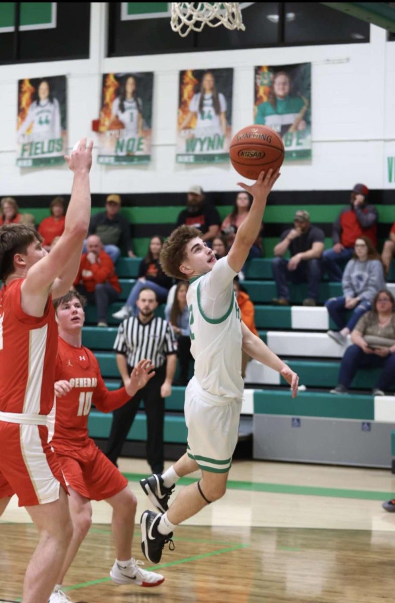 Harlan guard Ethan Huff went in for two of his 18 points in the Green Dragons’ win Friday over Lee, Va.