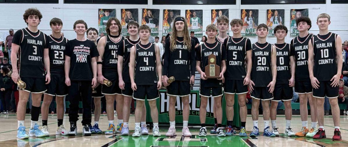 The Harlan County Black Bears are pictured after winning their third straight 52nd District Tournament title with a 61-51 win over Bell County on Friday at Harlan.