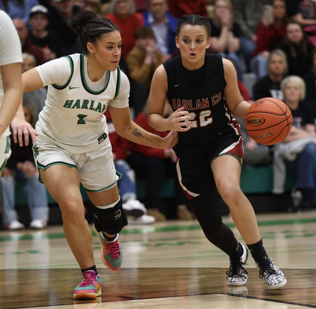 Harlan County freshman guard Kylee Runions worked to the basket against Harlan's Kylie Noe in the 52nd District Tournament finals Thursday. Runions led the Lady Bears with 14 points in a 55-47 loss.