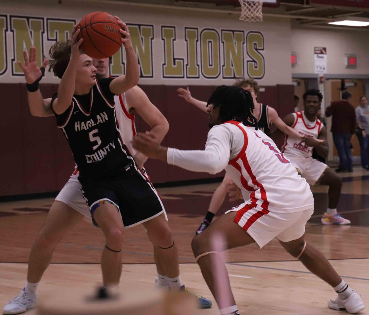 Harlan County junior guard Brennan Blevins passed out of a trap during an 84-61 win Saturday over Scott County in the Gem City Classic at Pineville.