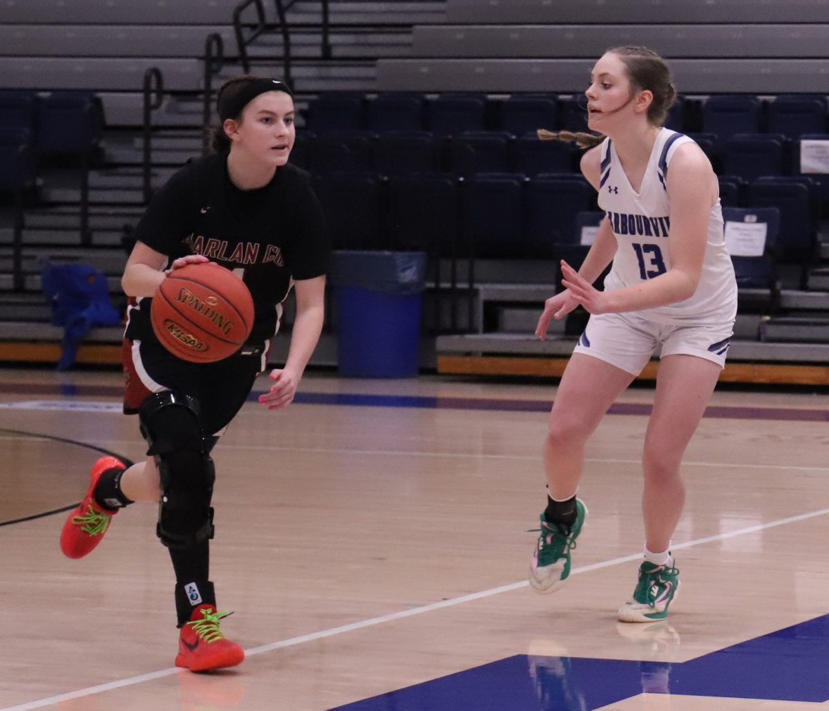 Harlan County guard Reagan Clem dribbled past Barbourville's Marleigh Martin in Saturday's game. Clem led the Lady Bears with 20 points in a 54-43 win.