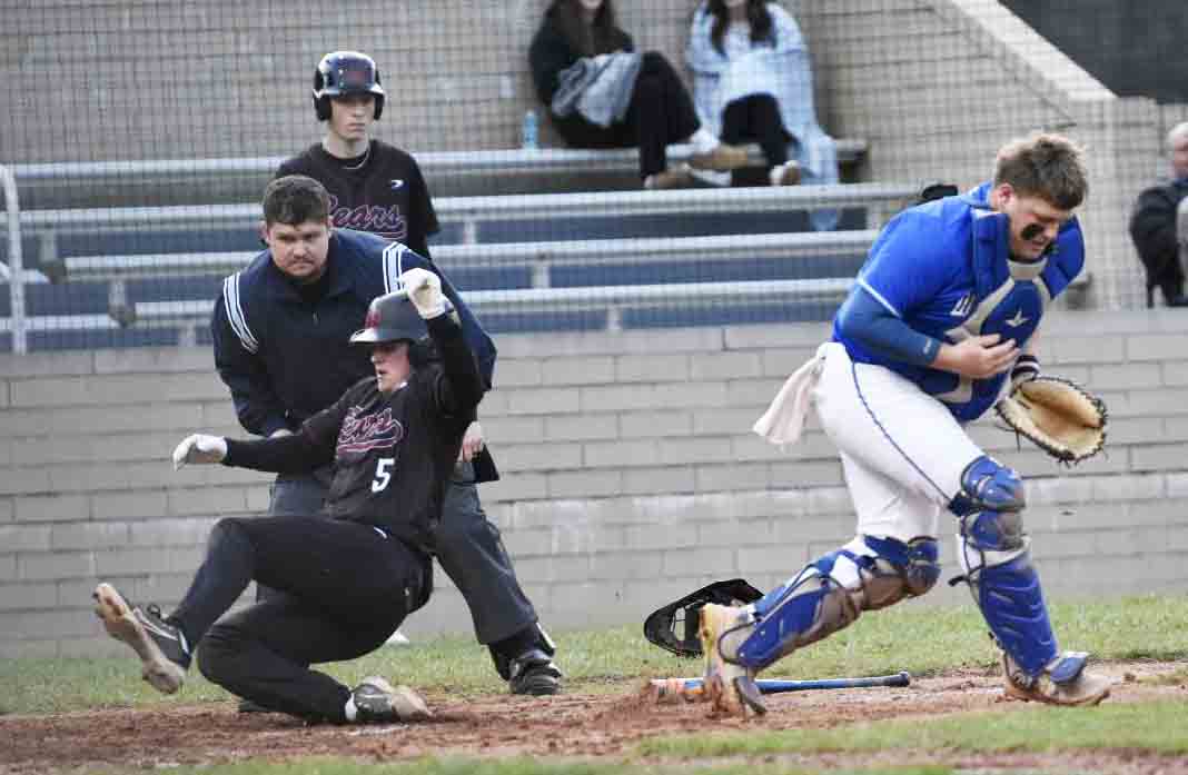 Harlan County junior Chance Sturgill slid home with a run in the second inning of Monday's game against Shelby Valley.