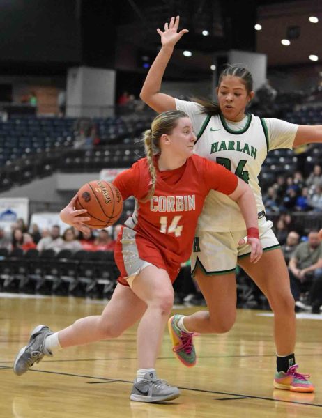 Corbin guard Raegan Walker drove to the basket as Harlan's Aymanni Wynn defended in 13th Region Tournament action Tuesday. Walker scored 23 points in the Lady Hounds' win.