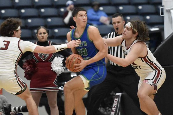 North Laurel junior Reece Davidson worked between Harlan County's Maddox Huff and Jaycee Carter for a shot in action from the 13th Region Tournament semifinals. Davidson led the Jaguars with 23 points in a 53-47 overtime victory.