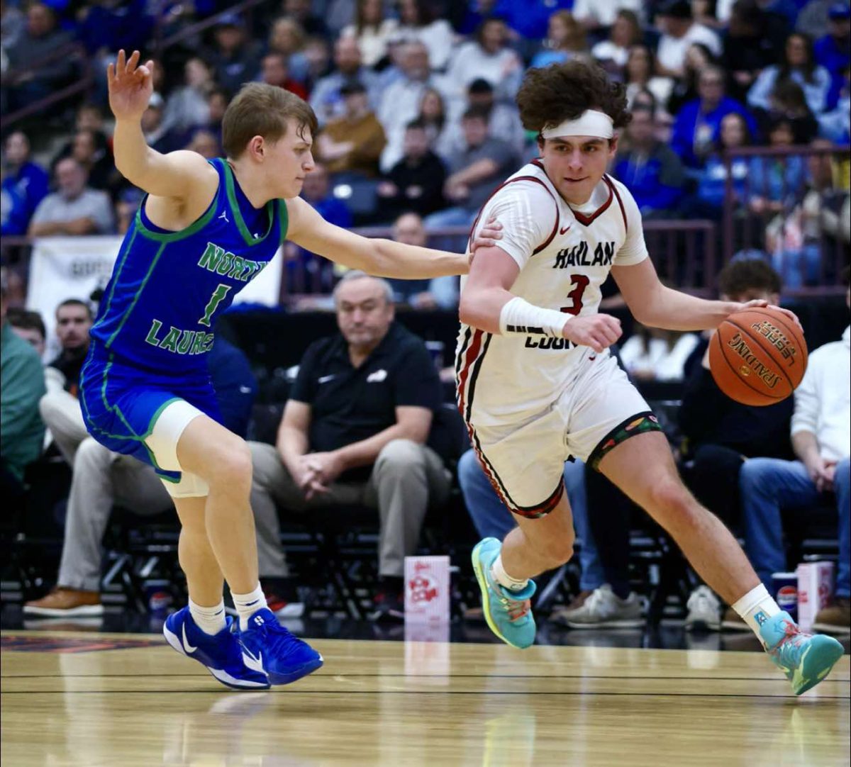 Harlan County's Maddox Huff drove against North Laurel's Cooper Elza in 13th Region Tournament action Saturday.