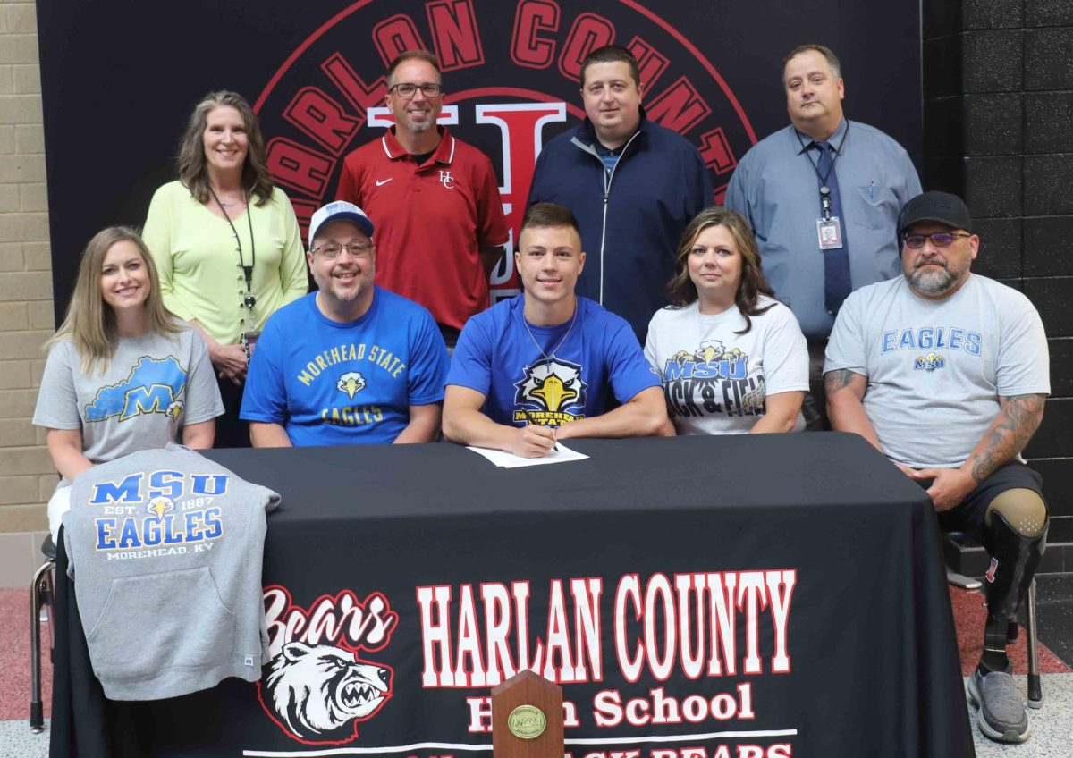 Harlan County senior Luke Kelly signed to continue his academic and athletic careers at Morehead State University. Pictured with Kelly are, from left, front row: Tara Kelly, Matthew Kelly, Ashley Coldiron and Dion Coldiron; back row: HCHS Principal Kathy Napier, HCHS coach Ryan Vitiate, HCHS athletic director Eugene Farmer and Harlan County School assistant superintendent Brett Johnson.
