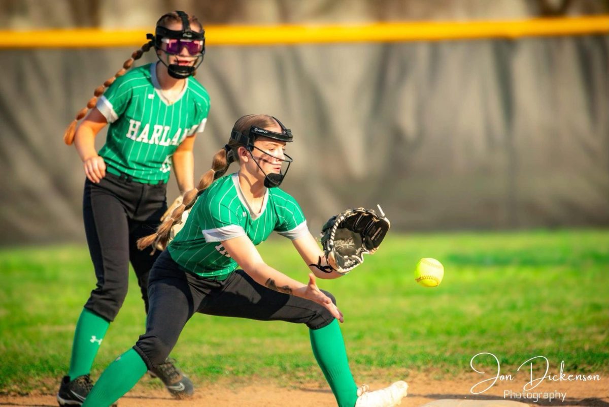 Harlan second baseman Daria Lee took a throw in middle school action earlier this season. Lee had a hit Thursday in the Lady Dragons' 8-4 win at Harlan County.