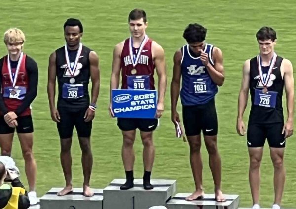 Harlan County senior Luke Kelly (center) became the second HCHS athlete to win a state track championship when he placed first Friday in the 100-meter dash in the 2A state meet at the University of Kentucky.