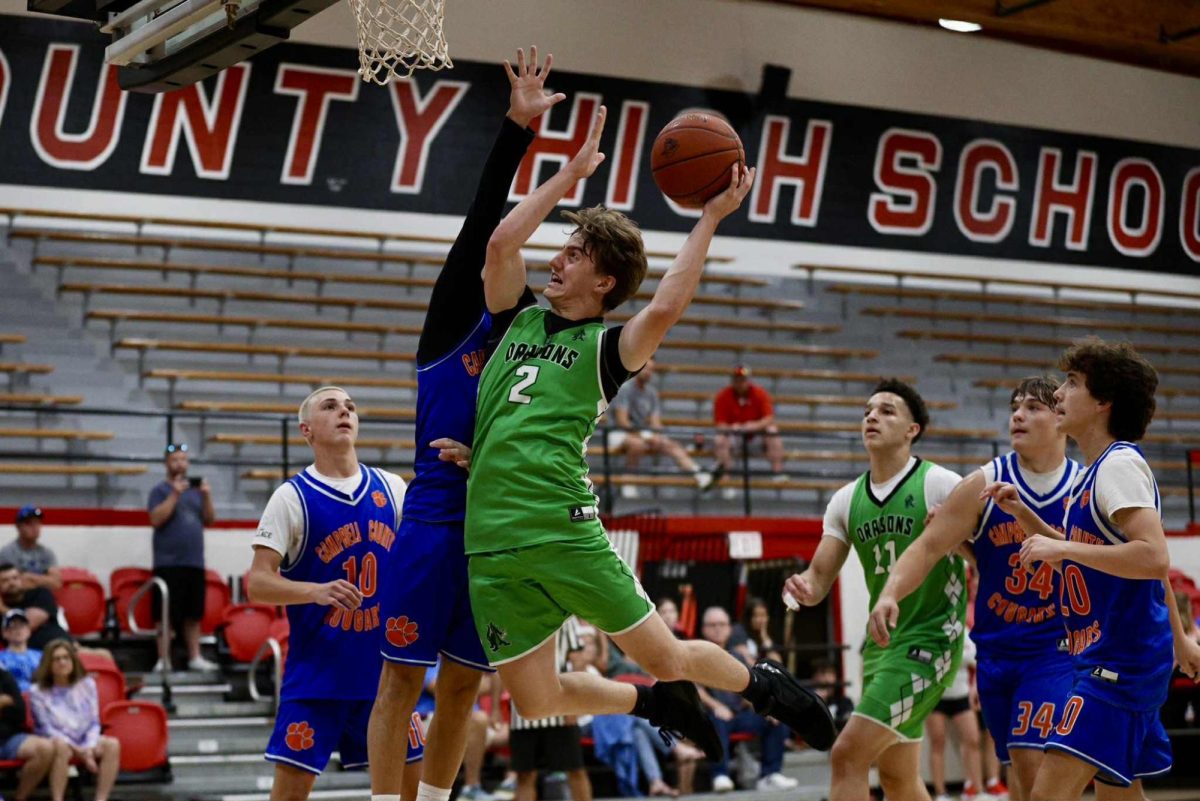 Harlan sophomore guard Jaxson Perry sailed to the basket in summer basketball action at Whitley County. The Green Dragons completed their summer slate on June 16-18 at UVA-Wise.
