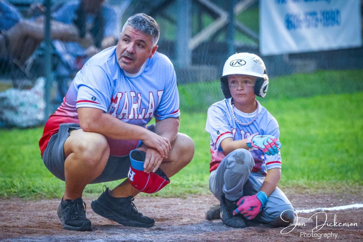 Harlan All-Stars coach Jason Capps talked with Ben Parsons during District 4 Tournament action.