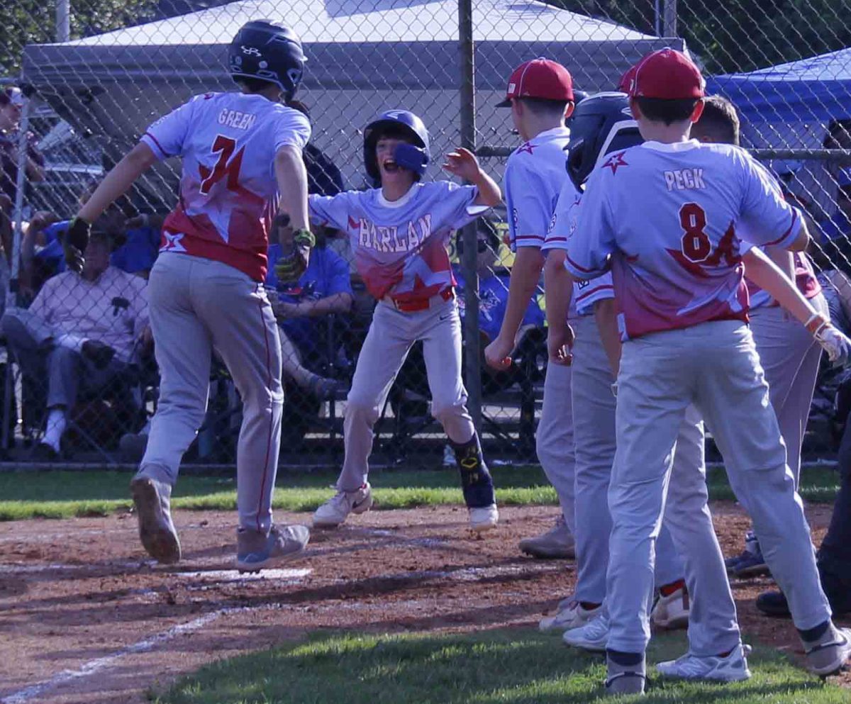 Harlan All-Star Kolbi Green was congratulated at the plate after his third-inning home run Friday in the District 4 Tournament at Barbourville. Harlan advanced with a 10-3 win over Middlesboro Pineville Bell.