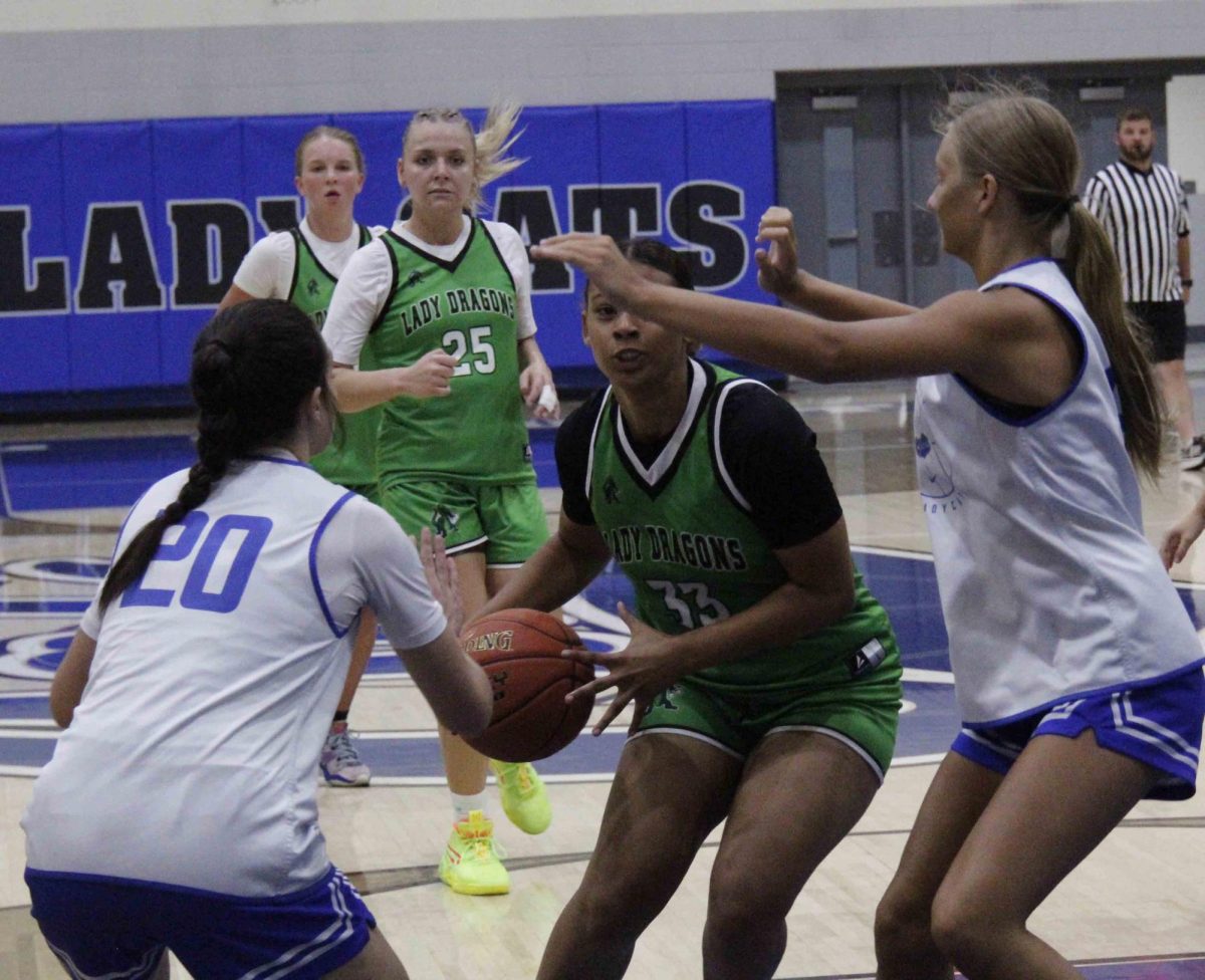 Harlan senior forward Raegan Goodman worked between two Bell County defenders in summer scrimmage action Friday at Log Mountain.