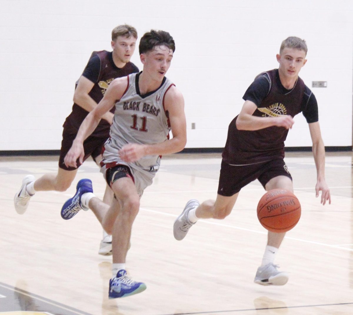 Harlan County junior guard Trent Cole raced down the court Monday in summer scrimmage action at Clay County. Cole scored 22 points to lead the Bears in a 70-29 rout of Leslie County.