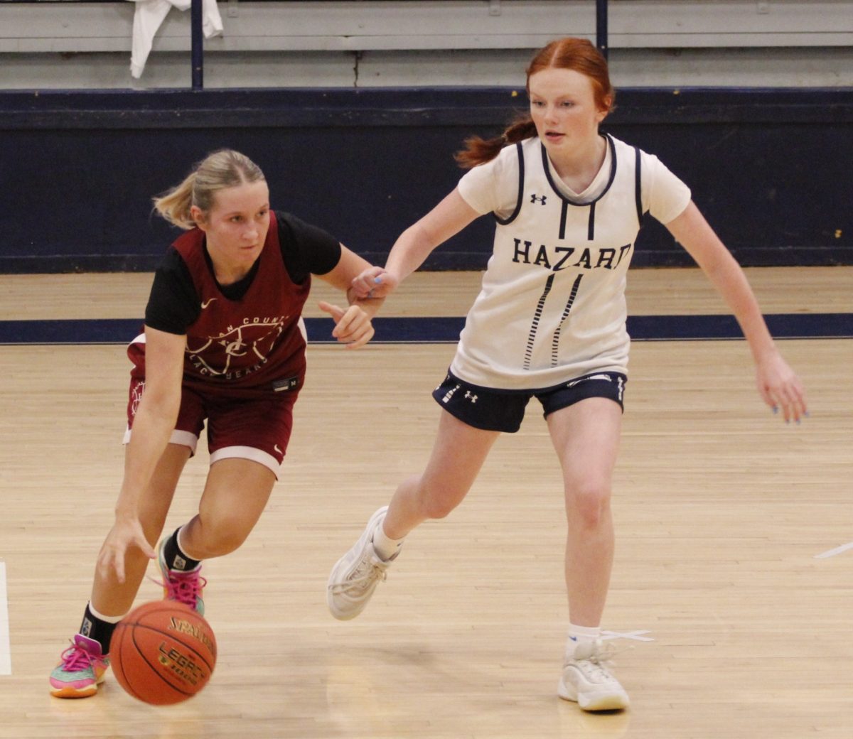 Harlan County senior guard Whitney Noe worked against Hazard's Emily Higgins in summer scrimmage action Monday. Noe scored eight points to help HCHS take an early lead, but Hazard rallied for a 51-47 victory.