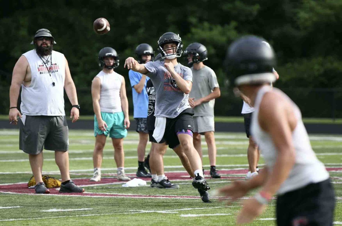Harlan County freshman Jackson Mackowiak tossed the ball to junior receiver Kayden Adams during a practice session last week.