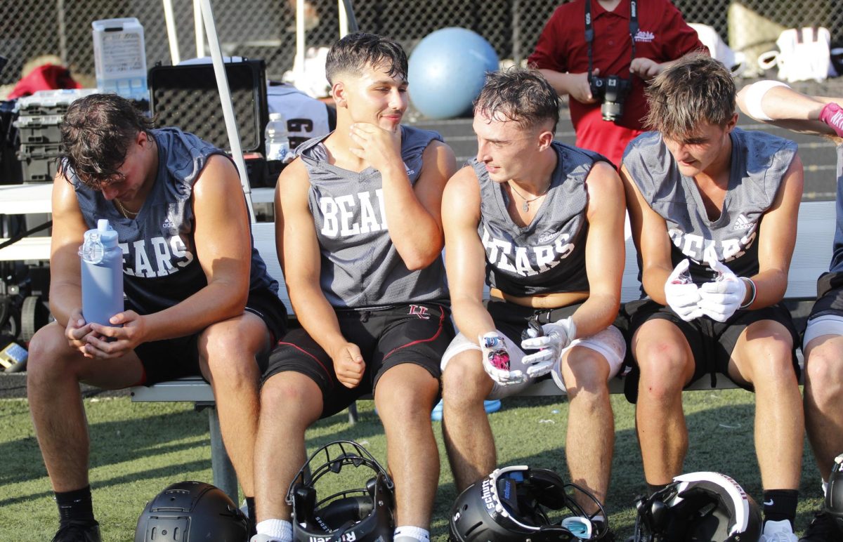 Harlan County players took a break during a scrimmage against Pineville.