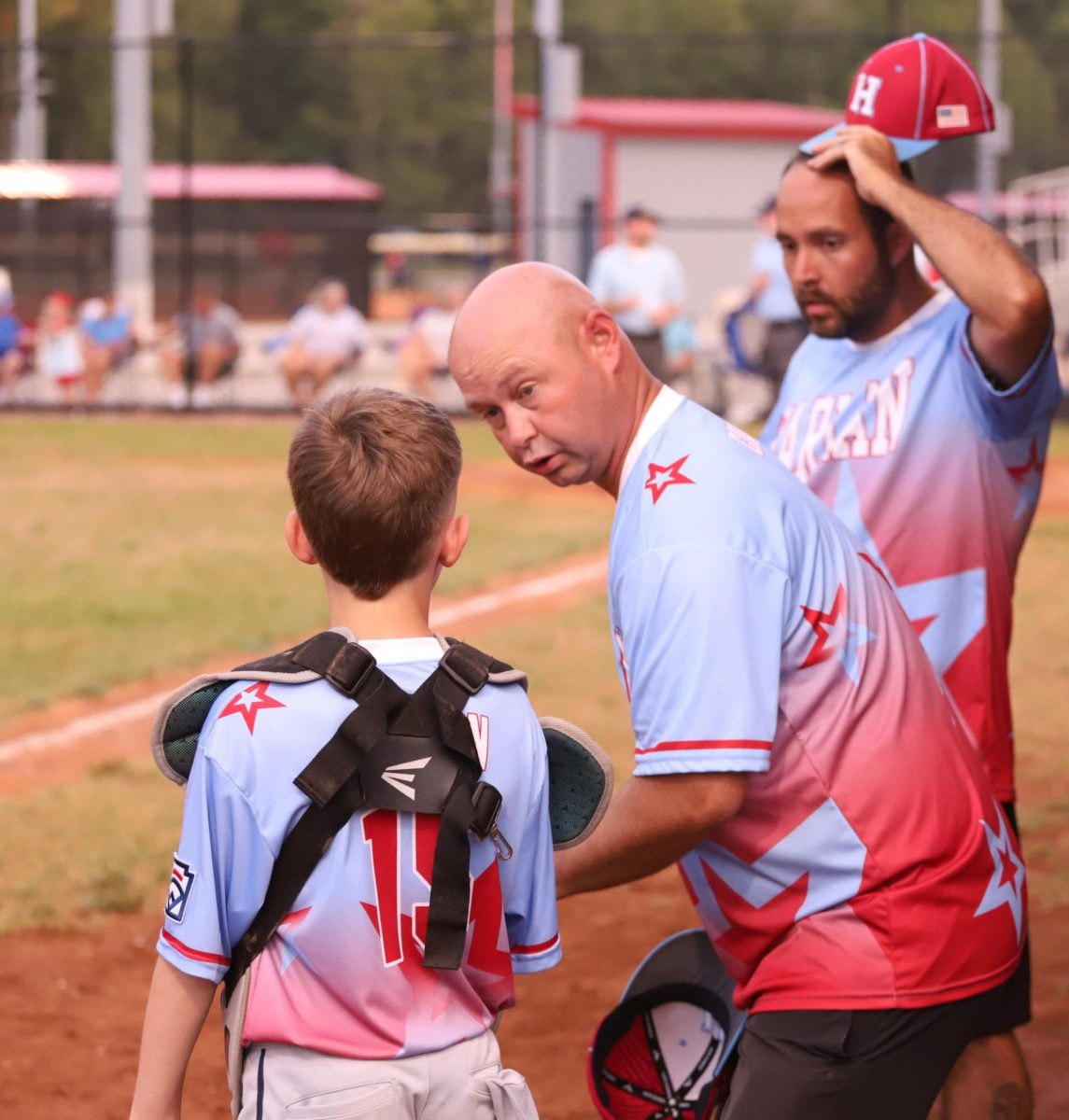 Harlan All Stars coach Steven Johnson talked with catcher Maddox Helton during District 4 Tournament action Wednesday. Harlan finished third in the district with an 18-8 loss to Knox County.