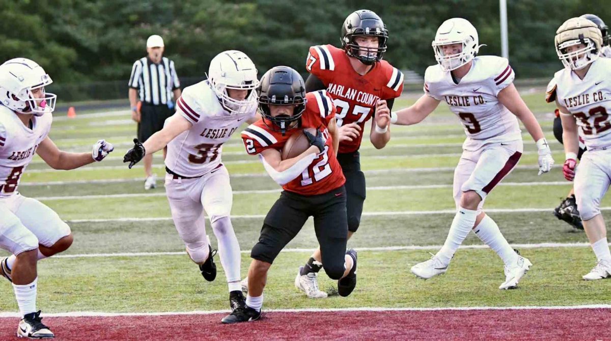 Harlan County junior running back Jonah Sharp raced into the end zone for one of his two touchdowns in the Black Bears’ 35-0 scrimmage win Friday over visiting Leslie County.