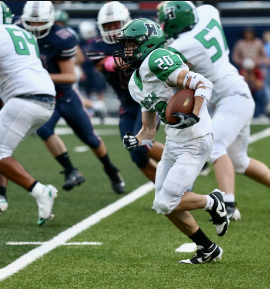 Harlan running back Eden Caudill worked outside for a short gain during the Green Dragons' opening game Friday at Knott Central. The Patriols coasted to a 50-0 victory.