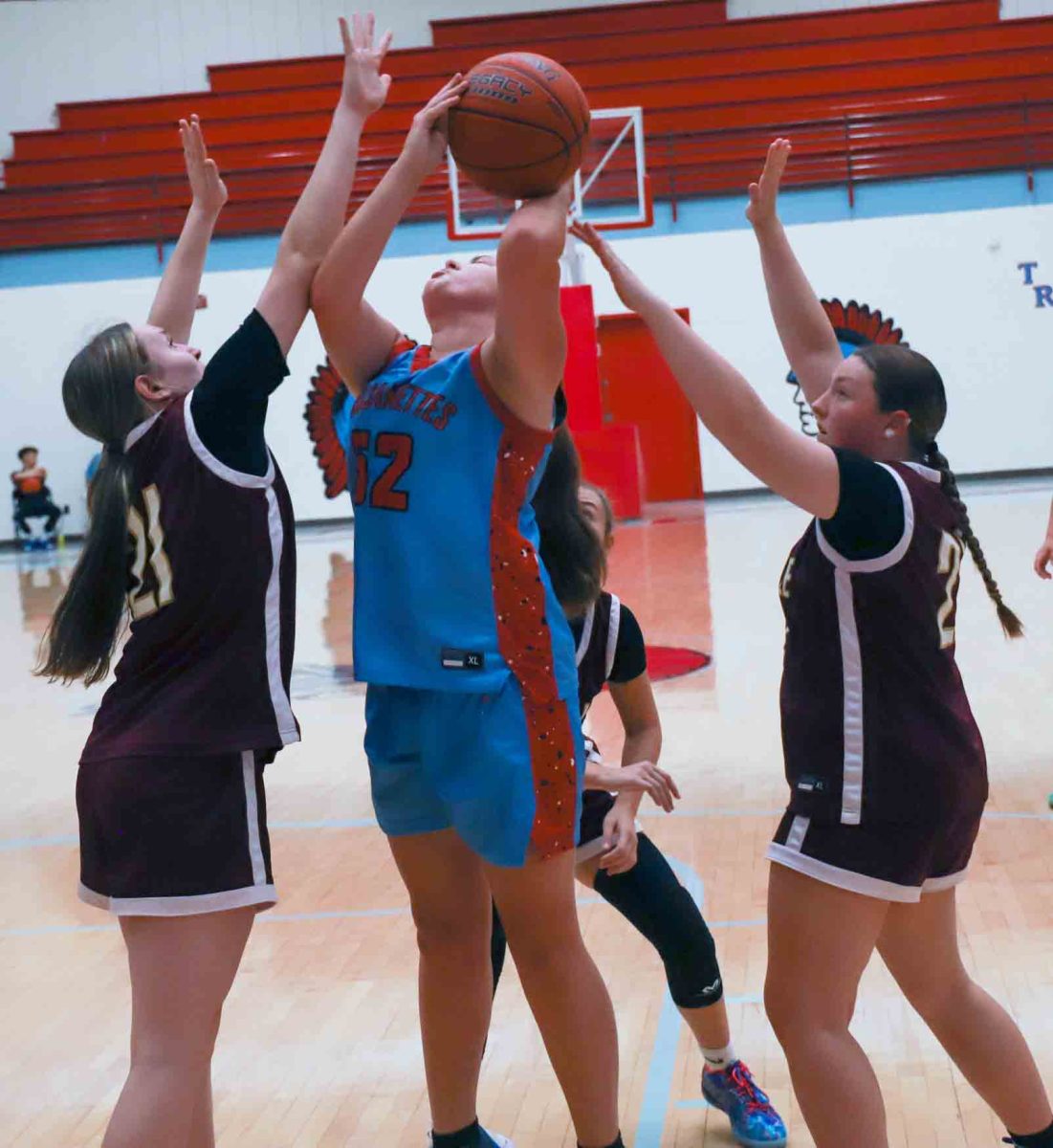 James A. Cawood's Natalie Moore battled inside for a shot Monday against Pineville in seventh- and eighth-grade basketball action. The visiting Lady Lions won 31-30 in overtime.