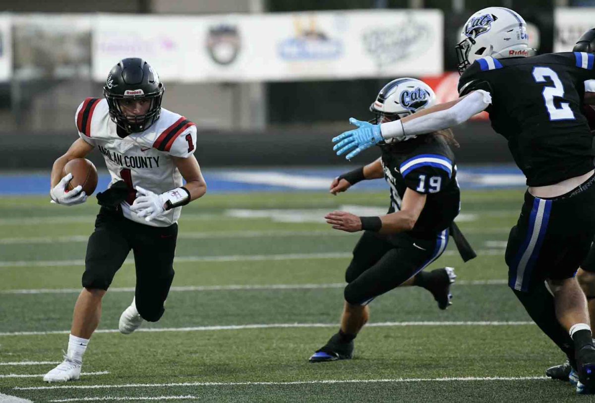 Harlan County junior receiver Kayden Adams picked up a short gain after one of his six catches Friday in the Black Bears' 36-7 loss at Bell County.