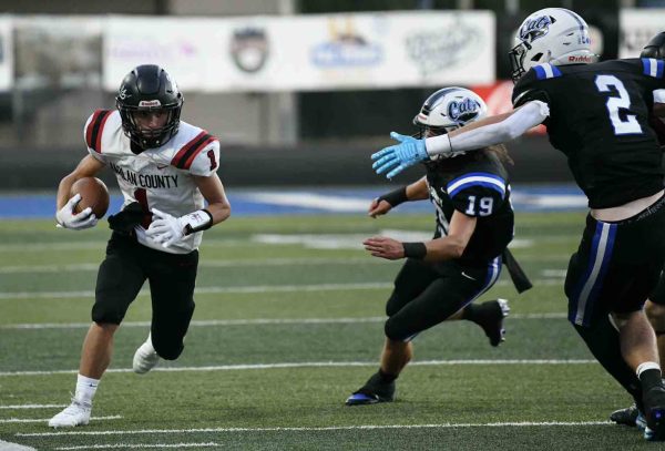 Harlan County junior receiver Kayden Adams picked up a short gain after one of his six catches Friday in the Black Bears' 36-7 loss at Bell County.