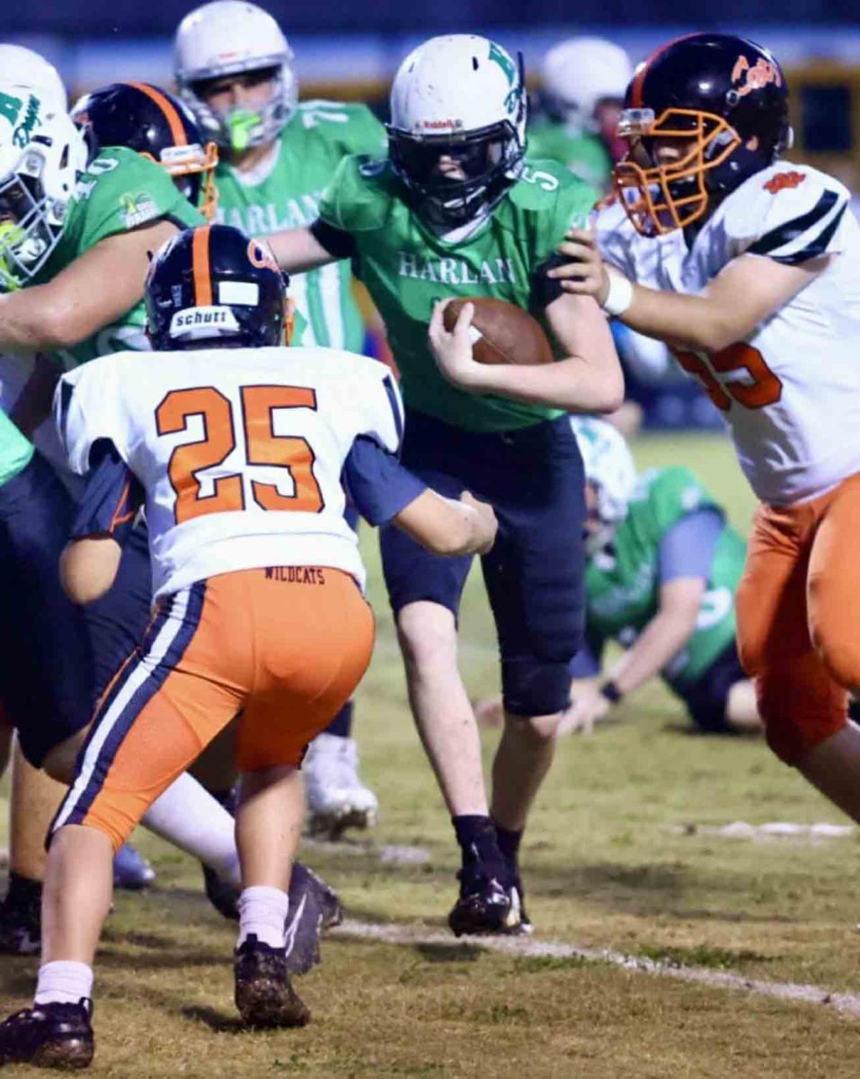 Harlan running back Brayden Clark battled for yardage in a seventh- and eighth-grade game Thursday against Lynn Camp. The visiting Wildcats edged Harlan 16-14.