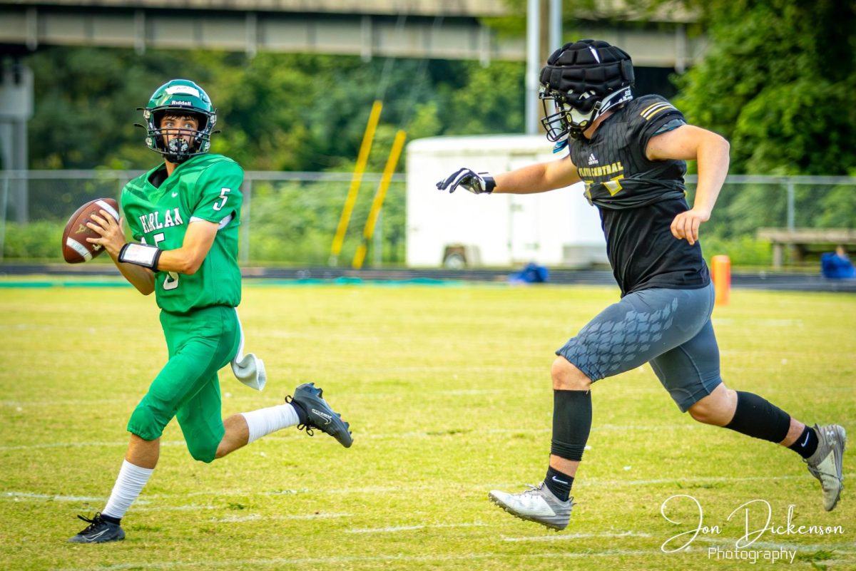 Harlan quarterback Elijah Caudill rolled out during action earlier this season. The Green Dragons fell to 0-3 with a 40-0 loss Friday at Phelps.