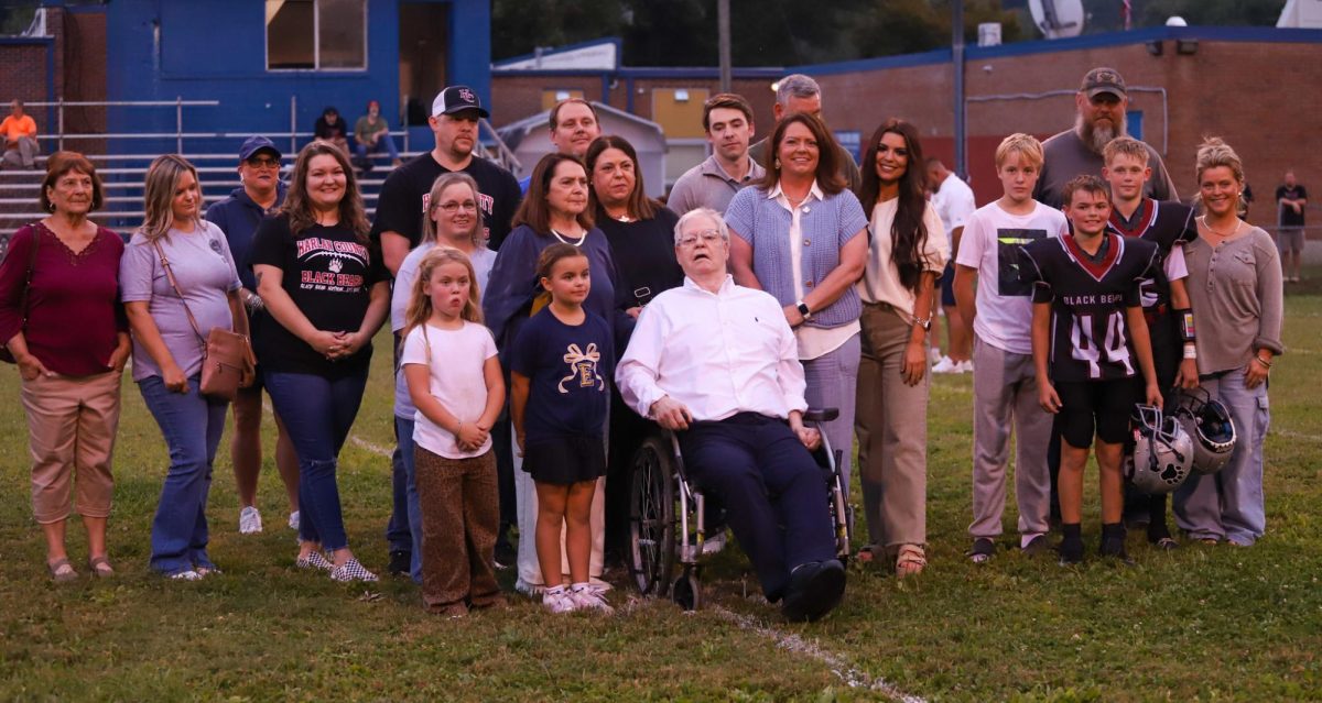 Perky Bryant is pictured with members of his family during ceremonies Tuesday at the Evarts football field. The street next to the football field and school was named Perky Bryant Pass in honor of the former Evarts star and University of Kentucky player.