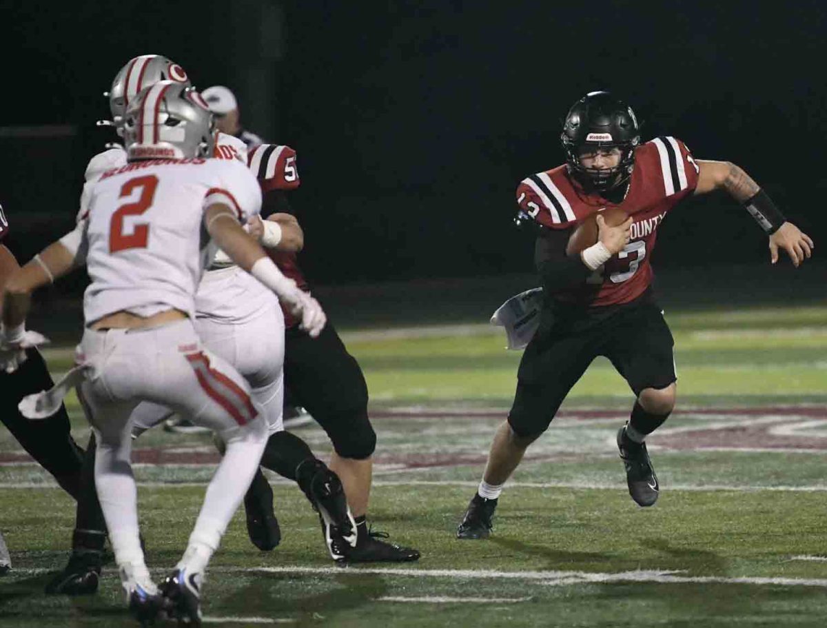 Harlan County quarterback Gunner Burkhart worked his way outside in Friday's game against visiting Corbin.