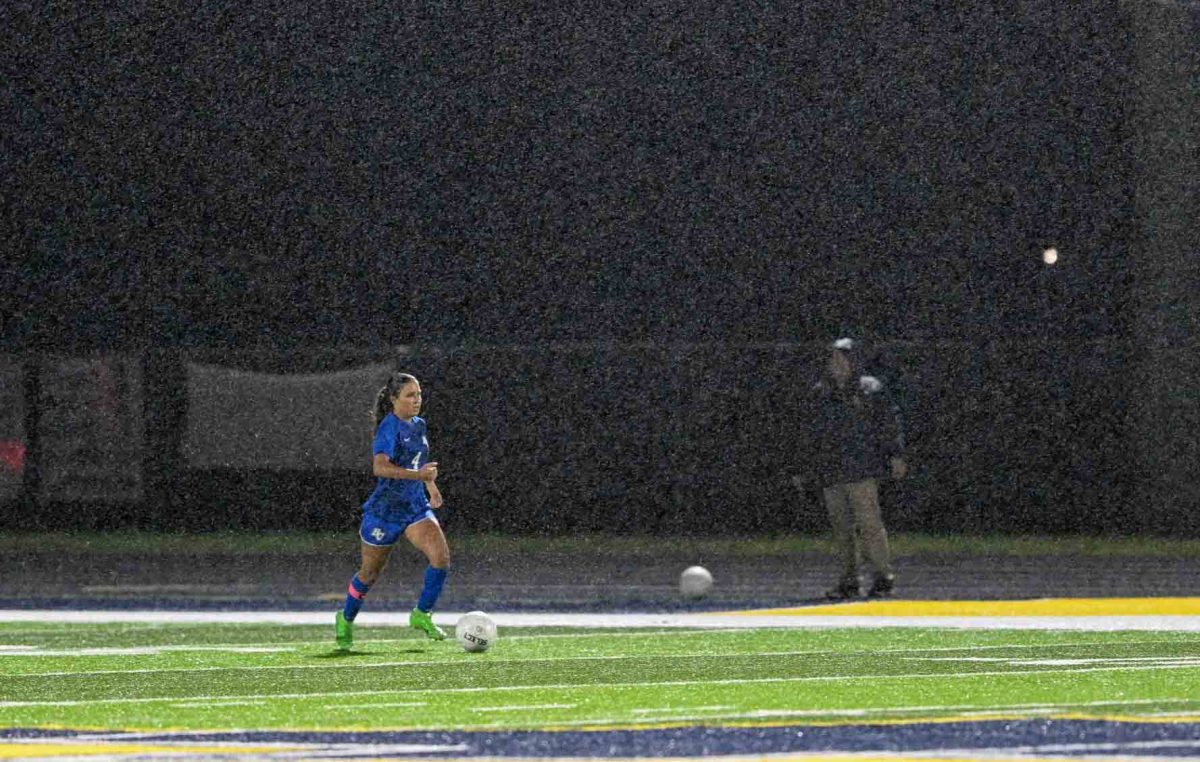 Bell County's Lyla Scearse ran through the rain as she moved down the field Tuesday in action from the 50th District Tournament. The Lady Cats advanced with a 12-1 win over Knox Central.
