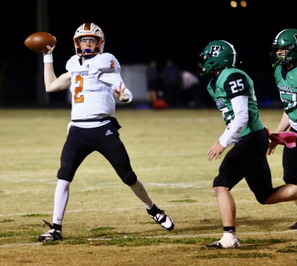 Williamsburg quarterback Reece Hatcher was chased by Harlan's Landon Kirby in Friday's district clash. Hatcher threw five touchdown passes in the Jackets' 56-8 victory.