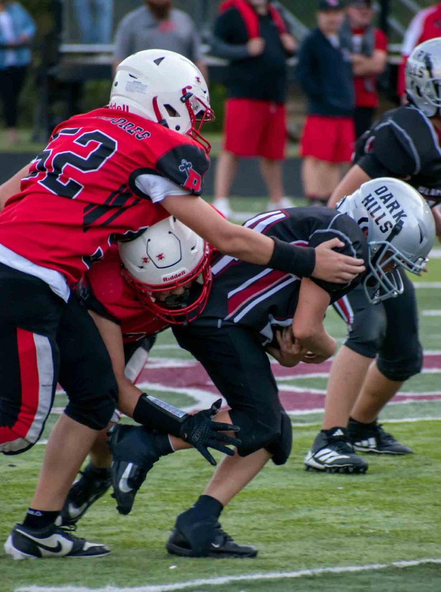 Harlan County's Brady White battled for yardage earlier this season in fifth- and sixth-grade football action. The Black Bears advanced to the regional finals with a 20-6 win Saturday over visiting Betsy Layne.
