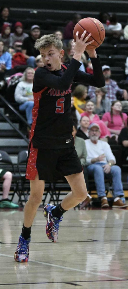 James A. Cawood guard Logan Mills pulled down a rebound during the Black Bears Panorama on Saturday. The Trojans split their first two games of the regular season.