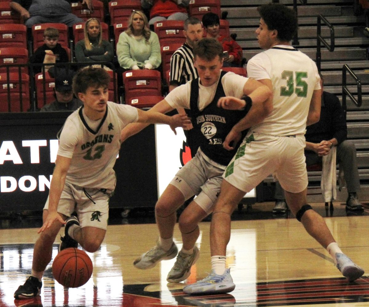Harlan sophomore guard Ethan Huff went around a pick from Kobe Noe during scrimmage action Saturday against Madison Southern in the G.J. Smith Showcase at South Laurel. Noe scored 17 points and Huff added 13 in the Dragons' 75-71 victory.