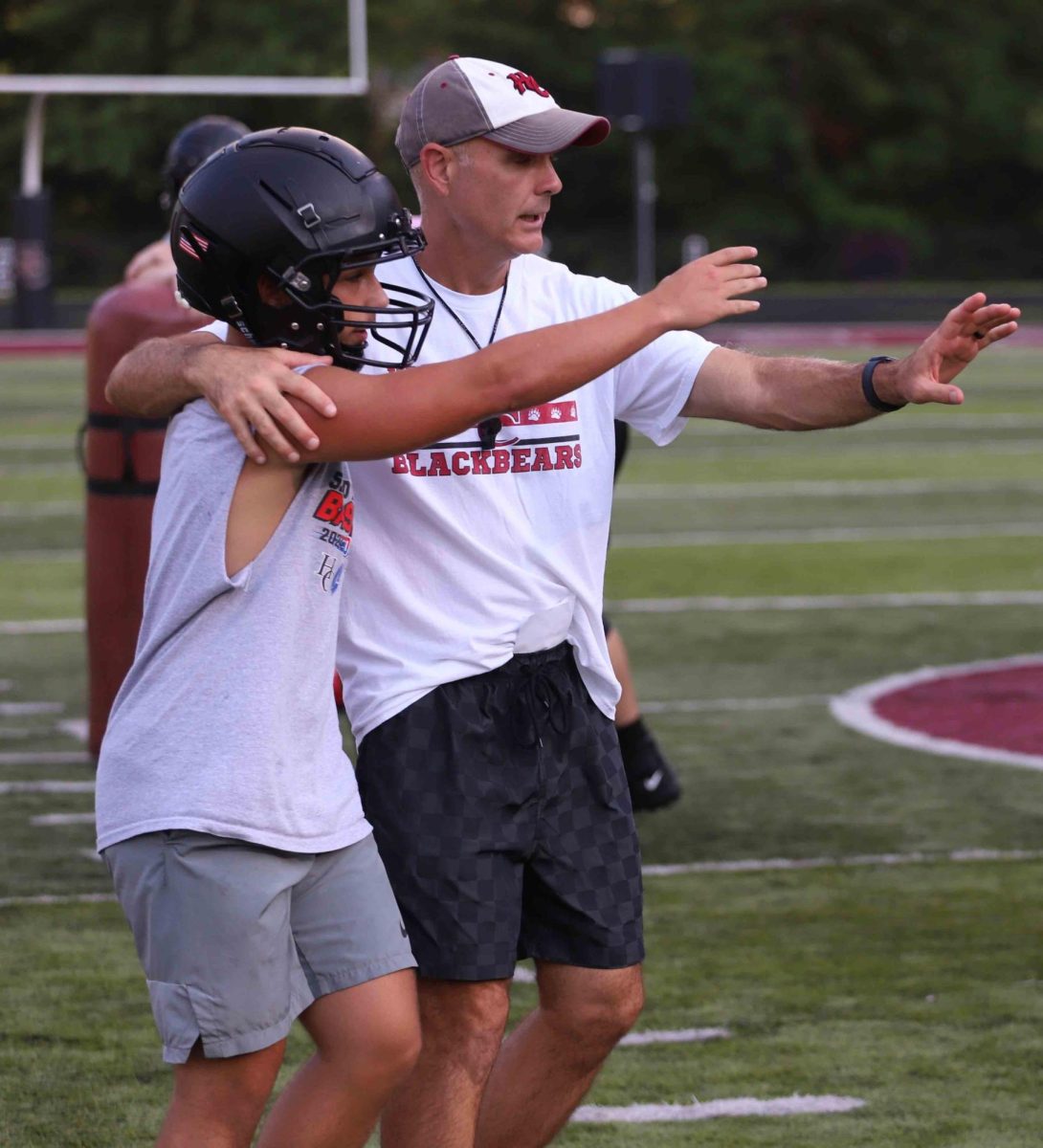 Harlan County coach Jacob Saylor, pictured talking with running back Rhylend Thomas in summer workouts, was named the District 8 Coach of the Year after leading the Bears to a 7-4 mark this season following last year's 1-9 finish.