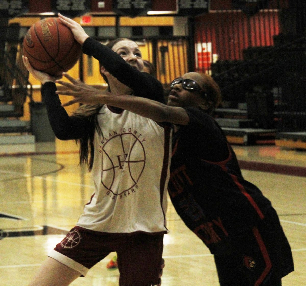 Harlan County guard Jaycee Simpson drew a foul as she drove to the basket in scrimmage against Saturday against Scott County.