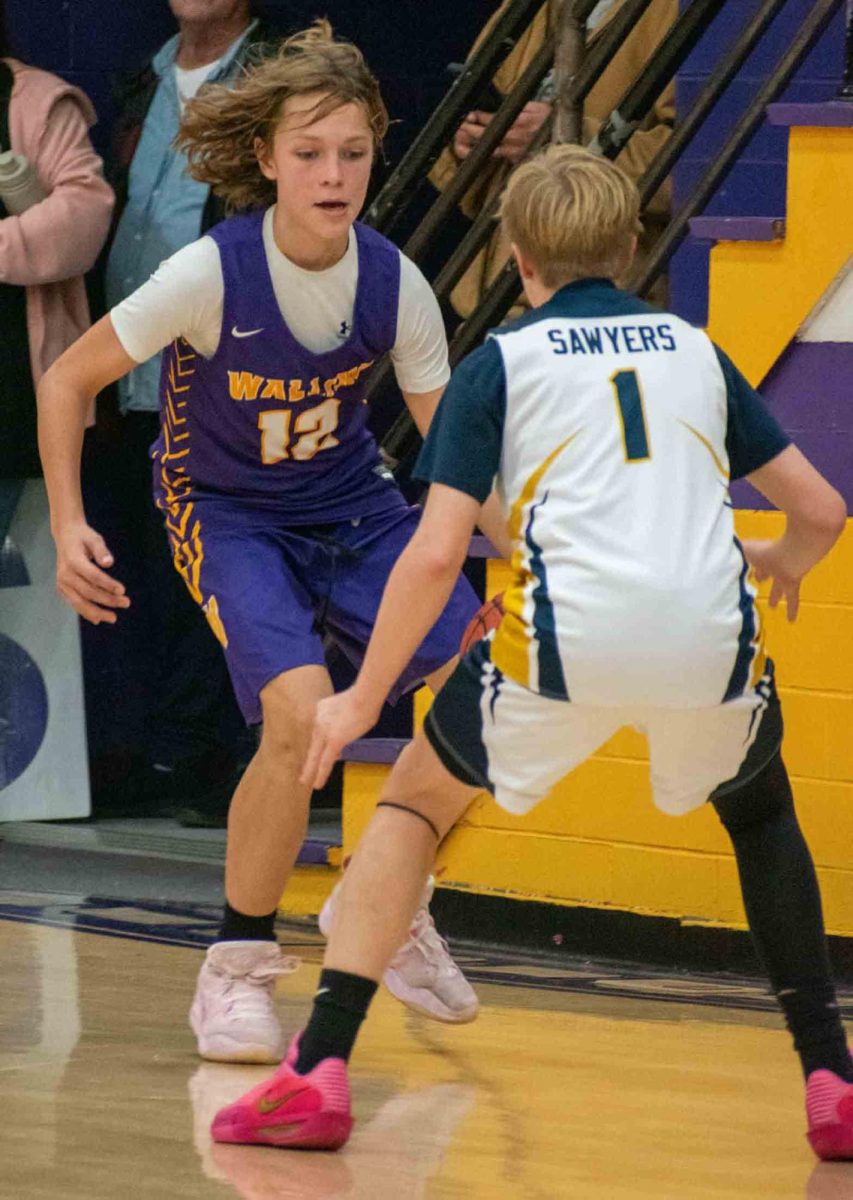Wallins guard Sam Carmical worked against Evarts' Carter Sawyers in middle school basketball action Monday.