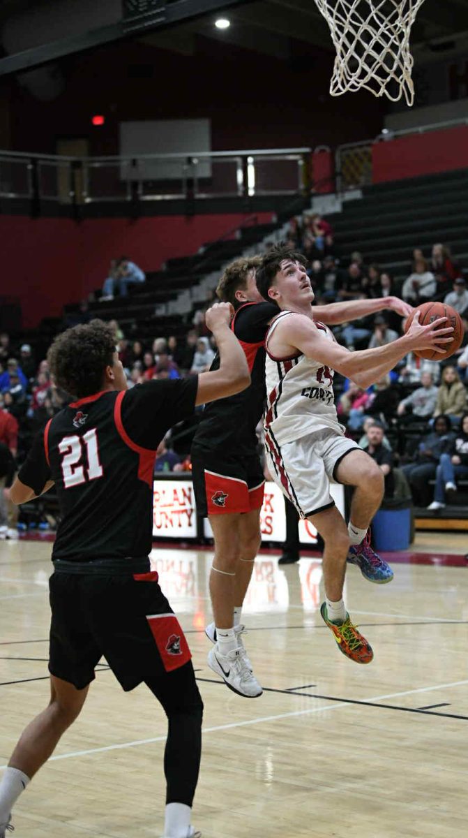 Harlan County junior guard Trent Cole went up for two of his team-high 22 points Saturday in the Bears' 76-71 season-opening loss to visiting Whitley County.